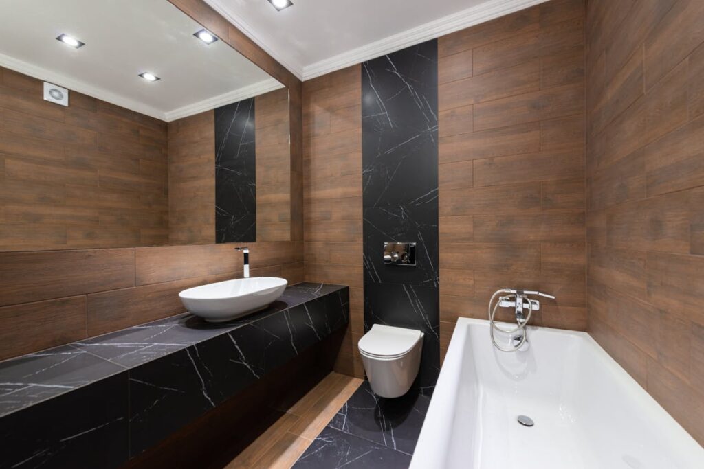Modern bathroom with wooden accents, sleek fixtures, and minimalist design.