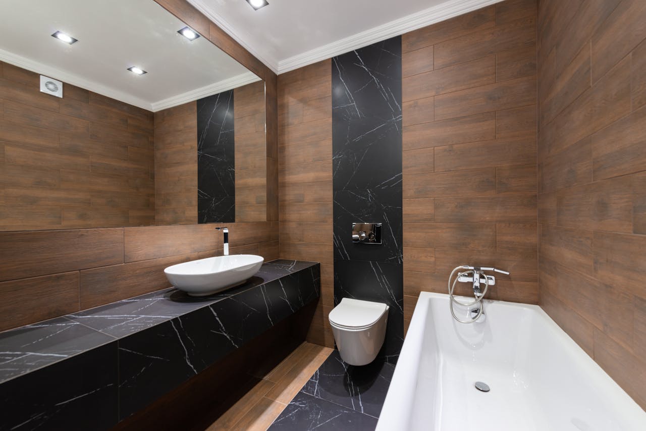 Mastering the First Impression: Your intriguing post title goes here Modern bathroom with wooden accents, sleek fixtures, and minimalist design.